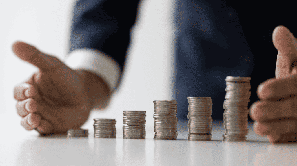 two hands protecting coins